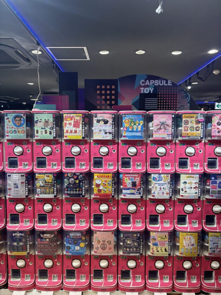 Wall of pink Gacha capsule toy machines at #C-Pla Shibuya